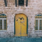 yellow front door of a brick house